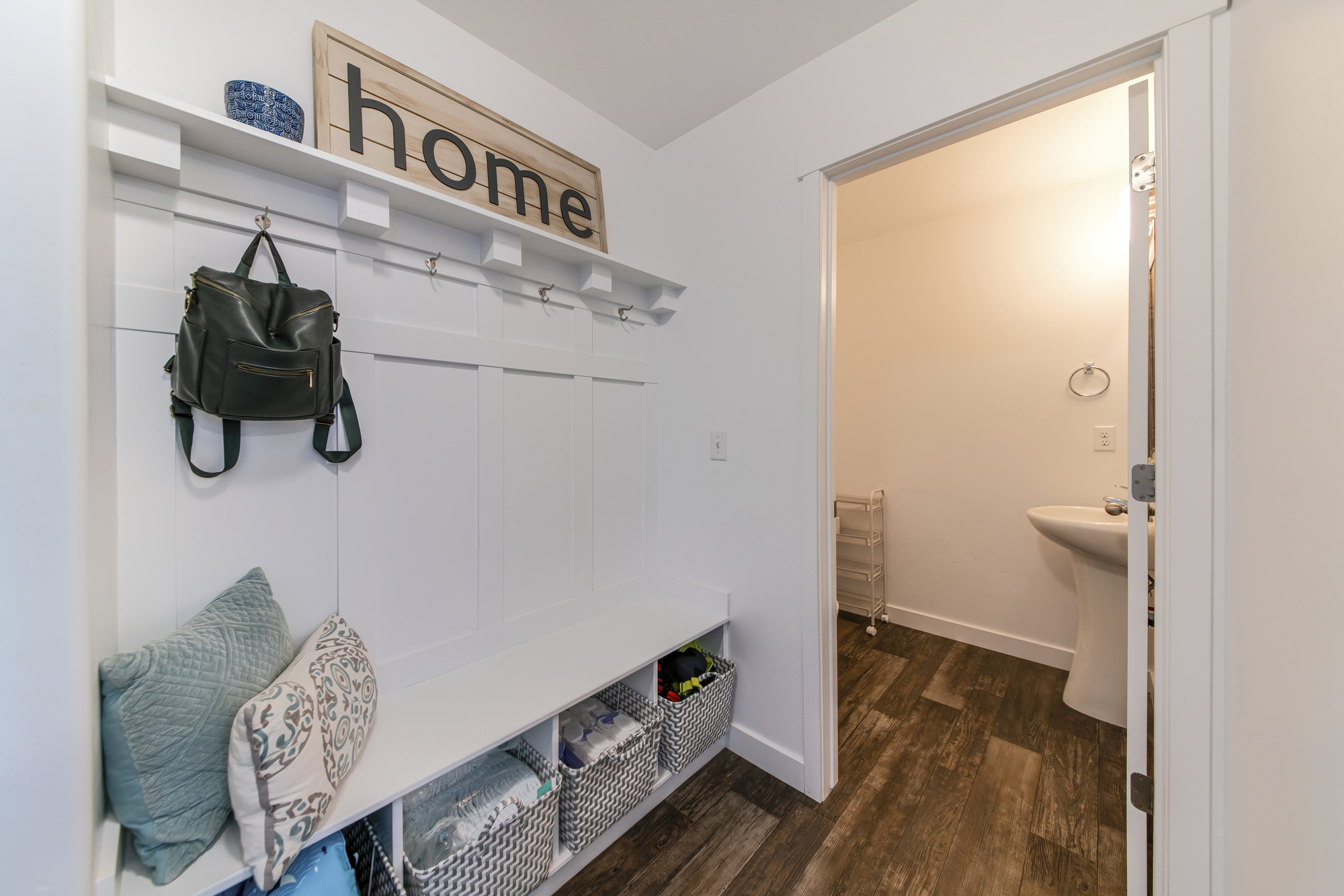 Mudroom with a view of a sink on the other room. 